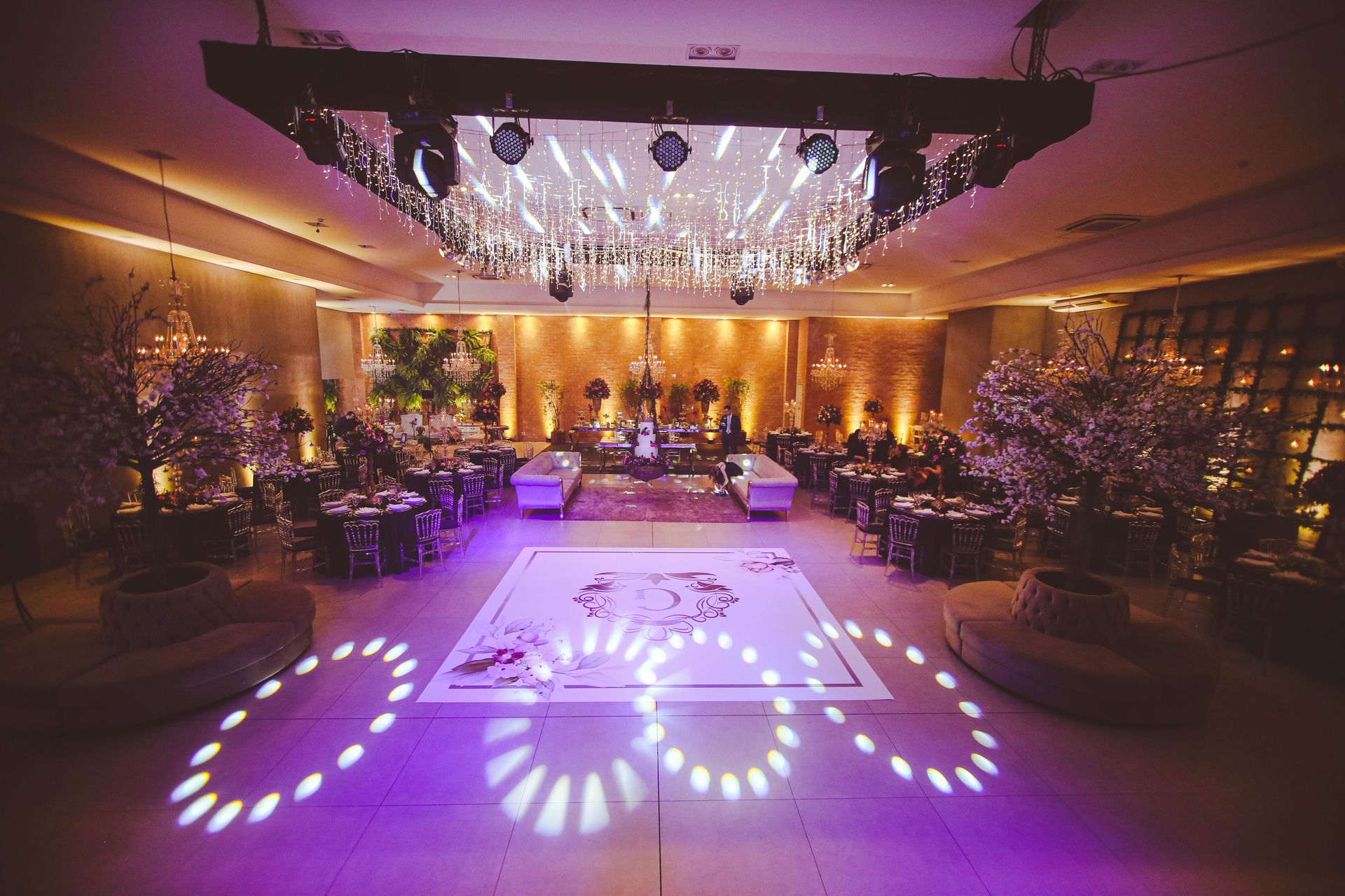 Opulent ballroom setting with chandeliers and sophisticated decor, ideal for upscale events.